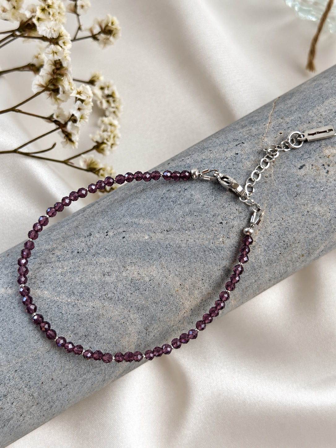 A delicate handmade bracelet featuring small faceted beads and silver-tone details. The beads catch the light beautifully, adding a subtle shimmer and a touch of colour to your everyday look. Wear it alone or layer it with your favourite bracelets.

Available in Plum Purple and Deep Blue — choose your favourite from the options.

Length: 18 cm + 5 cm extension chain, adjustable from 18 to 23 cm. Finished with a lobster clasp.