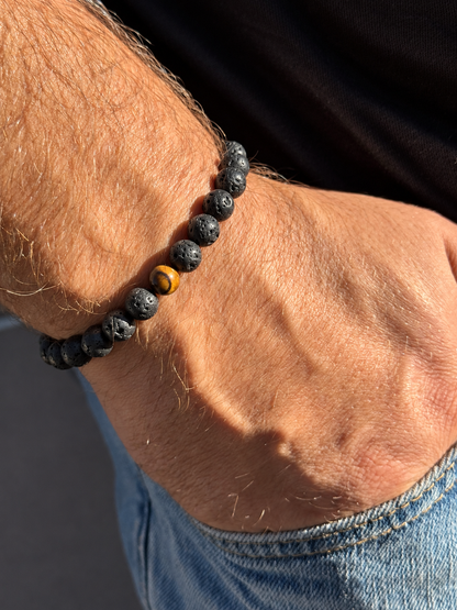A handmade bracelet featuring textured lava stone and a brown tiger’s eye accent with warm golden tones. A minimalist design, perfect worn alone or stacked with other bracelets.

Stone size: 8 mm
Bracelet size: approximately 18–18.5 cm