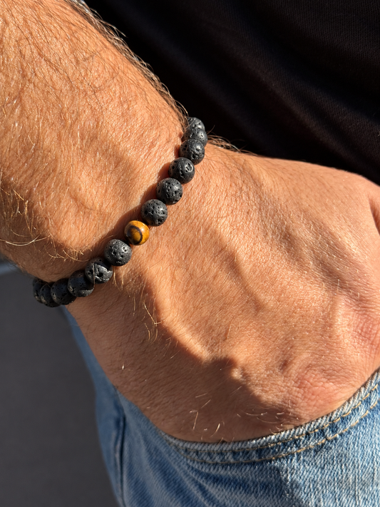 A handmade bracelet featuring textured lava stone and a brown tiger’s eye accent with warm golden tones. A minimalist design, perfect worn alone or stacked with other bracelets.

Stone size: 8 mm
Bracelet size: approximately 18–18.5 cm