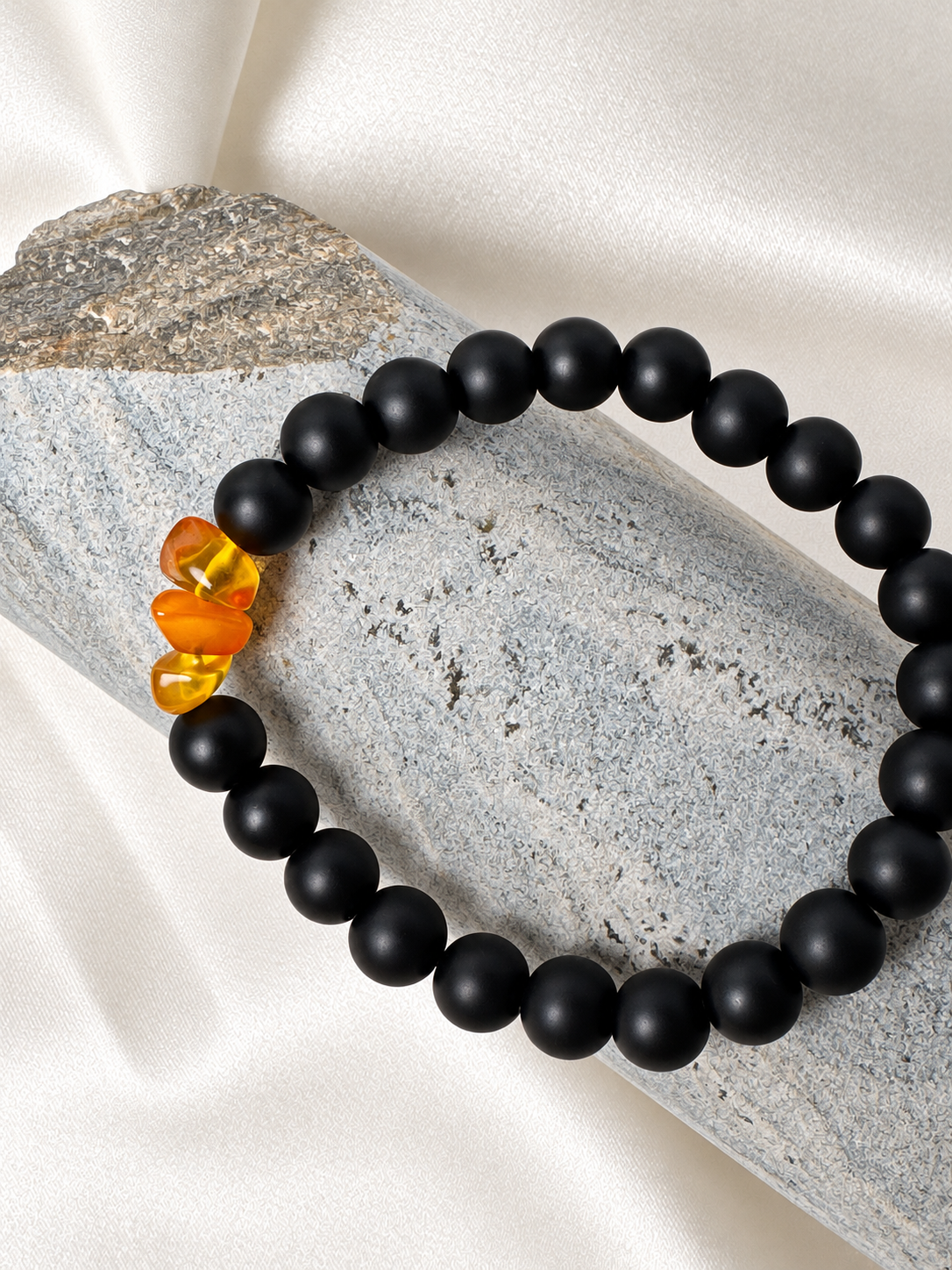 A handmade bracelet featuring matte onyx beads and warm amber-coloured accents. A minimalist design with a distinctive touch for everyday wear.

Stone size: 8 mm
Bracelet size: approximately 18 cm