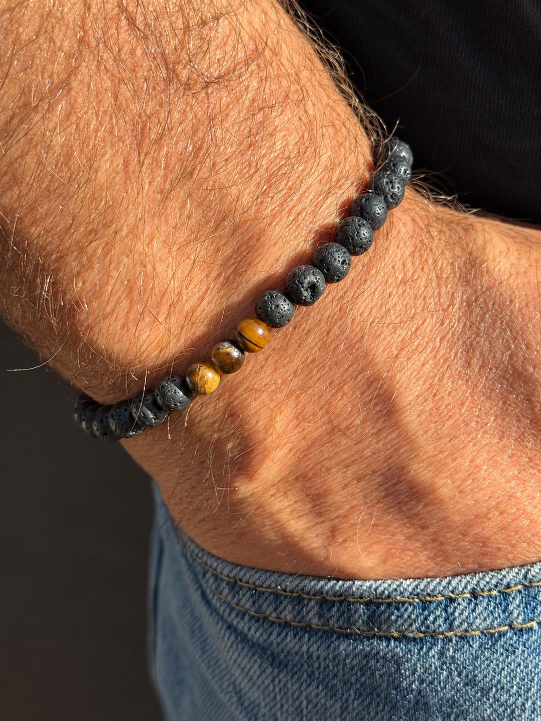 A handmade bracelet featuring textured lava stone and tiger eye accents in warm golden-brown tones. A minimalist design, perfect worn alone or stacked with other bracelets.

Stone size: 6 mm
Bracelet size: approximately 19–19.5 cm