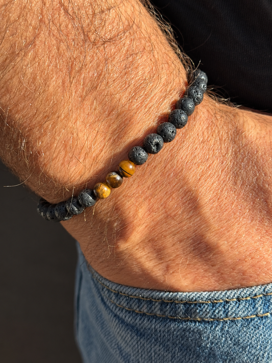 A handmade bracelet featuring textured lava stone and tiger eye accents in warm golden-brown tones. A minimalist design, perfect worn alone or stacked with other bracelets.

Stone size: 6 mm
Bracelet size: approximately 19–19.5 cm