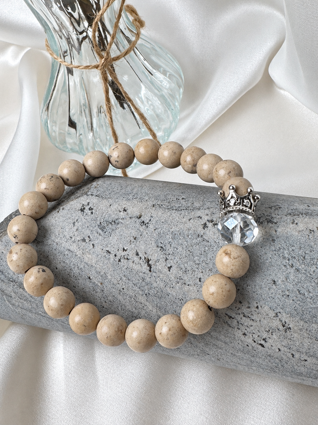 A handmade bracelet featuring stone in warm beige tones, a clear faceted accent and a silver-tone crown detail. An elegant design, perfect worn alone or stacked with other bracelets.

Stone size: 8 mm
Bracelet size: approximately 18 cm