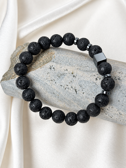 Lava Edge Bracelet

A handmade bracelet featuring textured lava stone and polished hematite accents. A bold, minimalist design with a distinctive cube detail for everyday wear.

Stone size: 10 mm
Bracelet size: 20.5–21 cm