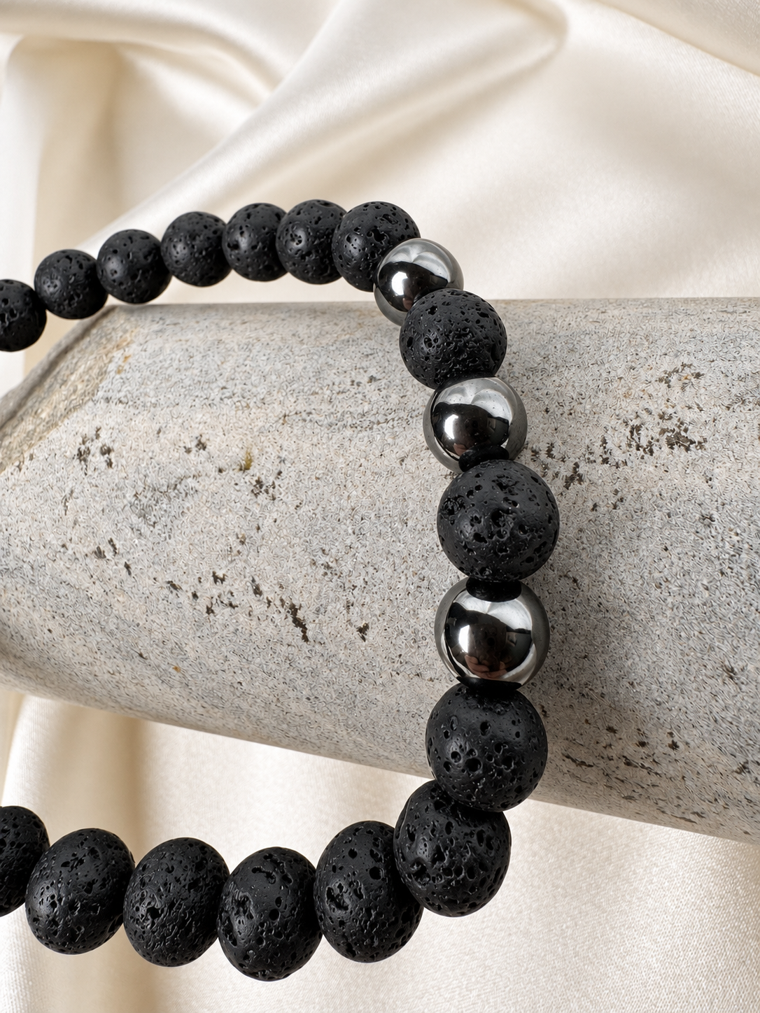 A handmade bracelet featuring textured lava stone and polished hematite accents. A minimalist design for everyday wear, perfect worn alone or stacked with other bracelets.

Stone size: 8 mm
Bracelet size: approximately 20 cm