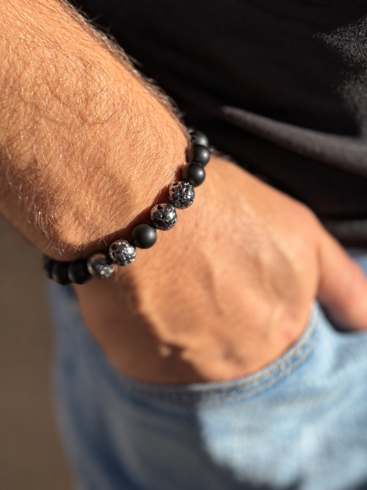 A handmade bracelet combining matte onyx with textured lava stone accents. A minimalist design with a distinctive contrast of textures, perfect worn alone or stacked with other bracelets.

Stone size: 10 mm
Bracelet size: approximately 20–20.5 cm